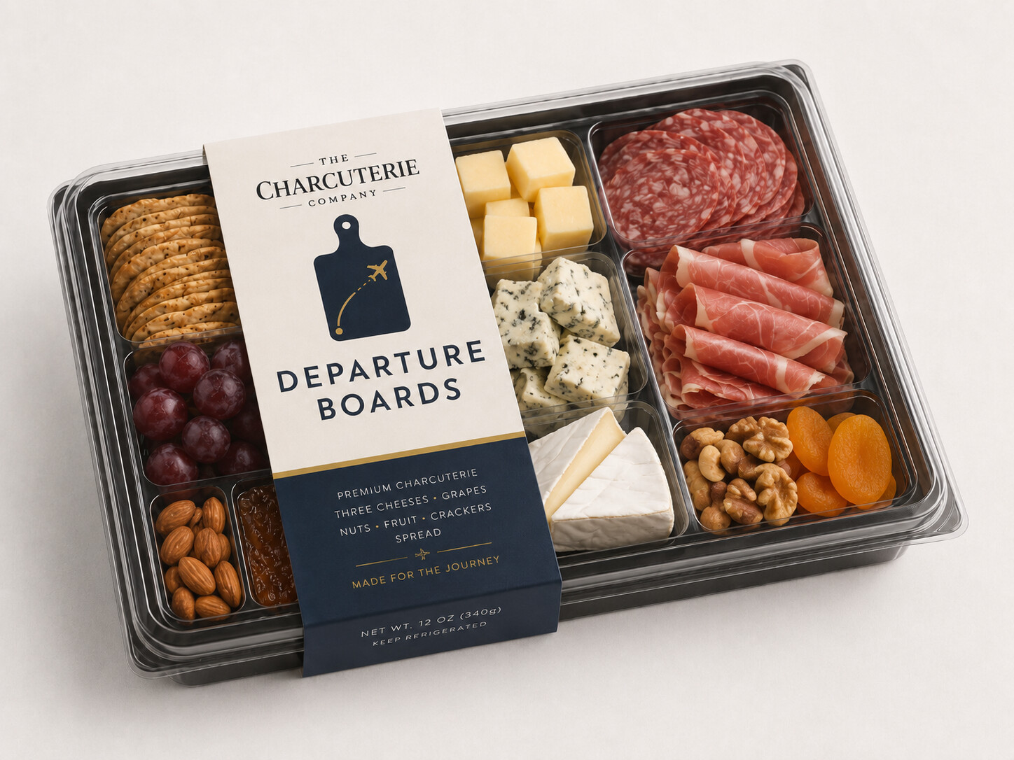 Concept packaging for a Departure Boards tray: labelled sleeve over a clear-lidded tray of crackers, grapes, almonds, cheeses, salami, and prosciutto